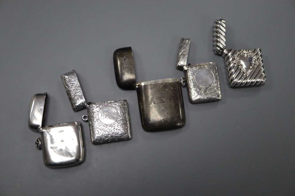 Three silver vesta cases, a sterling vesta case and a white metal vesta case, largest 61mm.